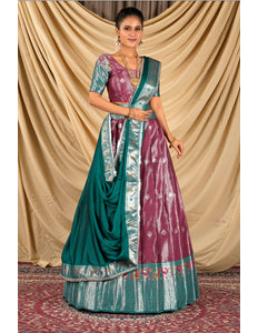 Woman wearing a traditional outfit with a green and pink lehenga choli