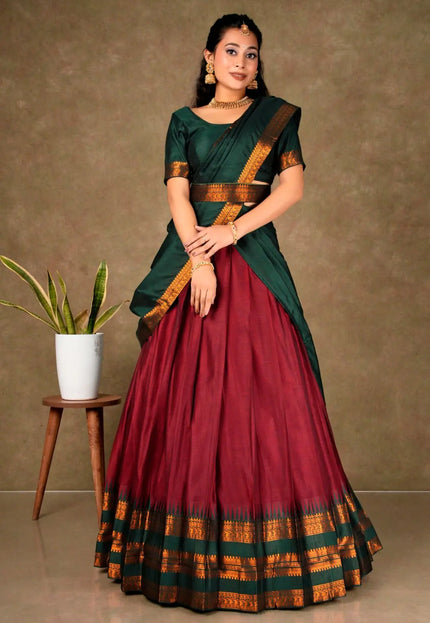 Woman wearing a traditional green and red lehenga choli with dupatta