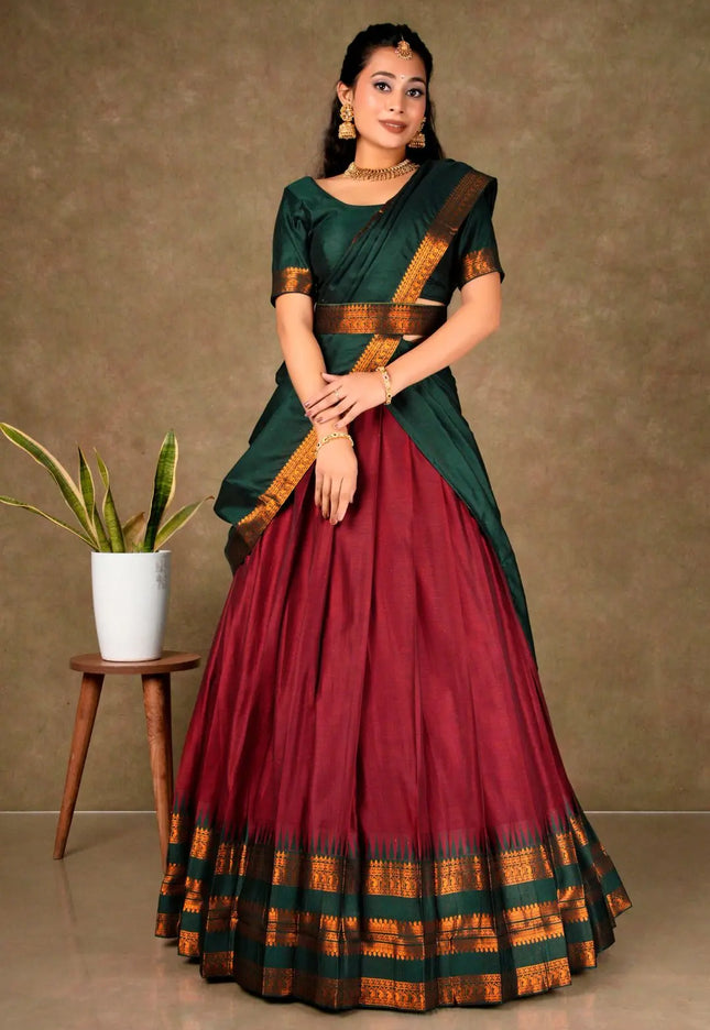 Woman wearing a traditional green and red lehenga choli with dupatta