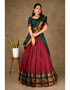 Woman wearing a traditional green and red lehenga choli with dupatta