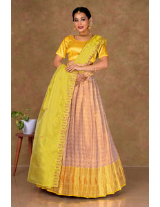 Woman wearing a Rust Lehenga with a Yellow blouse