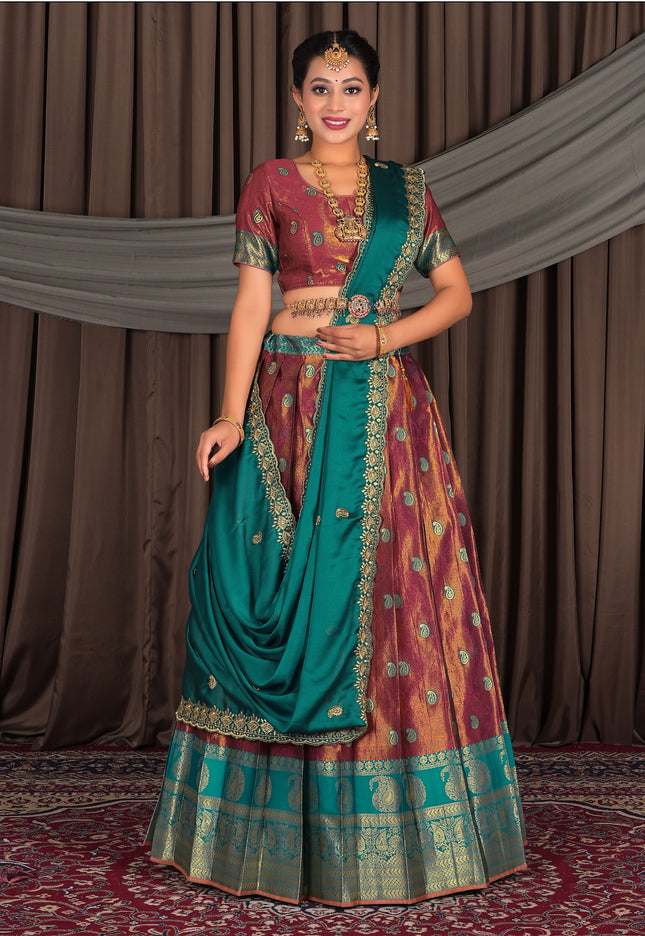Woman in traditional Indian attire with a maroon lehenga with matching blouse