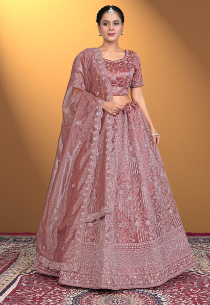 Woman wearing a traditional pink embroidered outfit
