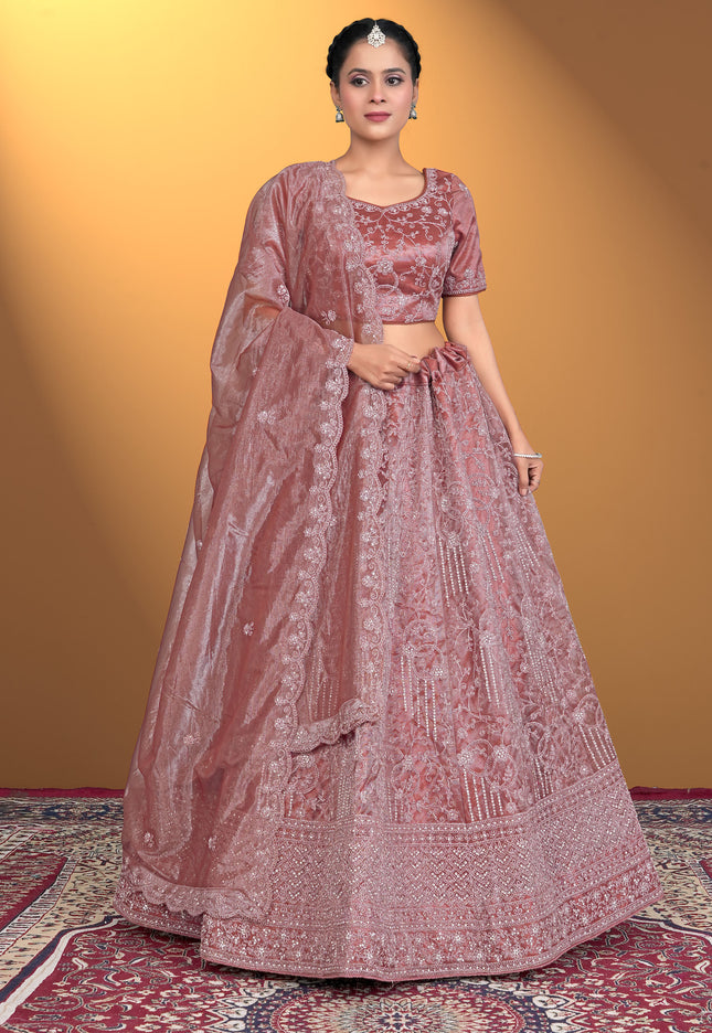 Woman wearing a traditional pink embroidered outfit