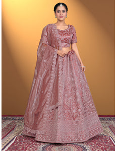 Woman wearing a traditional pink embroidered outfit