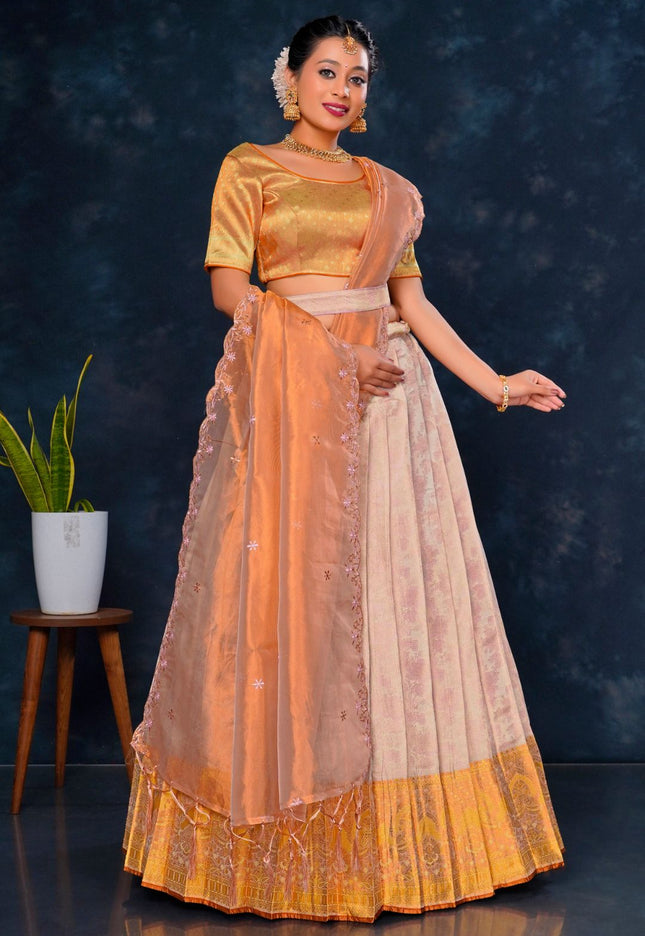 Woman in traditional outfit with orange and beige colors