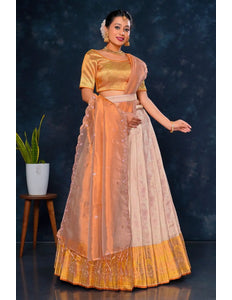 Woman in traditional outfit with orange and beige colors