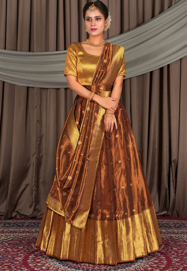 Woman wearing a traditional gold and rust lehenga choli with dupatta