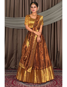 Woman wearing a traditional gold and rust lehenga choli with dupatta