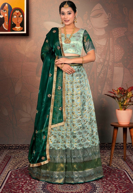 Woman in a green and light blue traditional lehenga choli with dupatta
