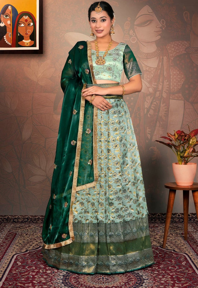 Woman in a green and light blue traditional lehenga choli with dupatta