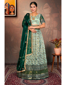 Woman in a green and light blue traditional lehenga choli with dupatta