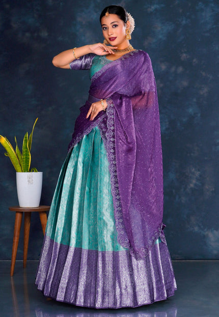 Woman in a sea green and purple lehenga choli with dupatta