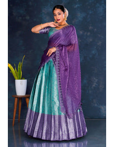 Woman in a sea green and purple lehenga choli with dupatta