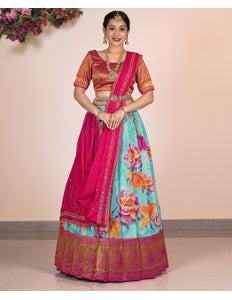 Woman wearing a traditional outfit with a floral skirt and pink blouse