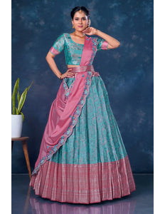 Woman wearing a traditional sea green and pink lehenga