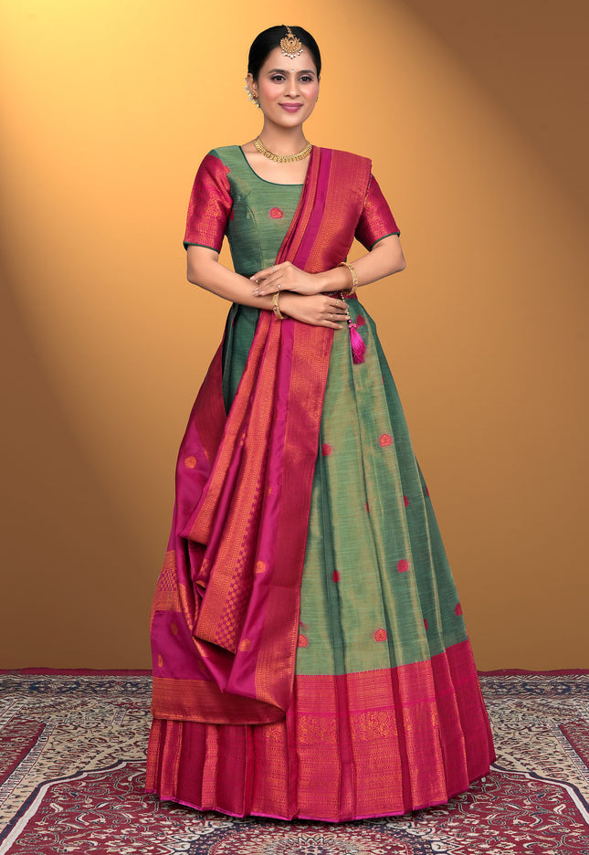 Woman wearing a traditional lehenga choli with a green and pink pattern