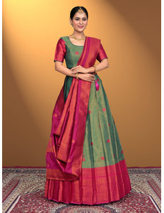 Woman wearing a traditional lehenga choli with a green and pink pattern