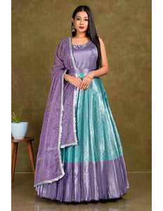 Woman wearing a purple and teal traditional outfit with a matching dupatta