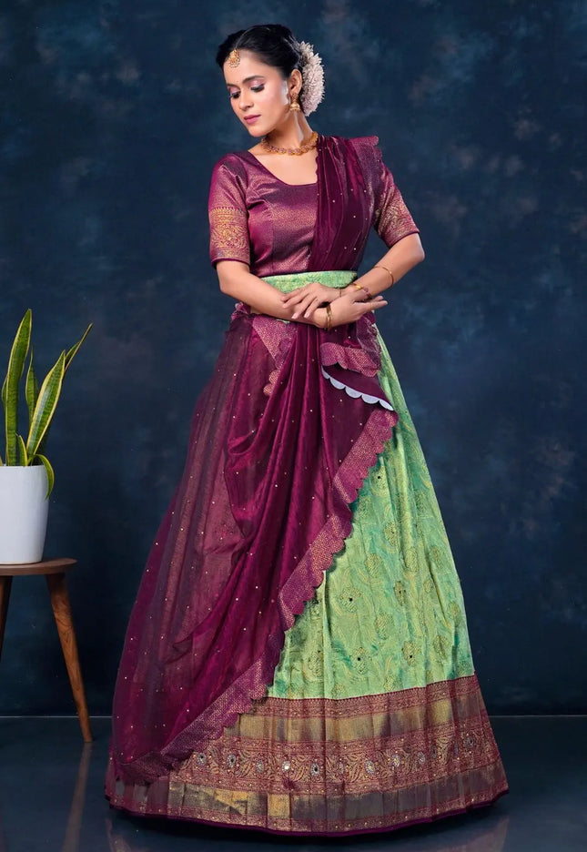 Woman wearing a traditional maroon and green lehenga choli with dupatta