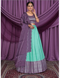 Woman wearing a traditional outfit with a purple and Sea Green Lehenga Choli