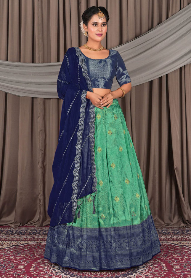 Woman wearing a traditional blue and green lehenga choli