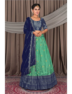 Woman wearing a traditional blue and green lehenga choli