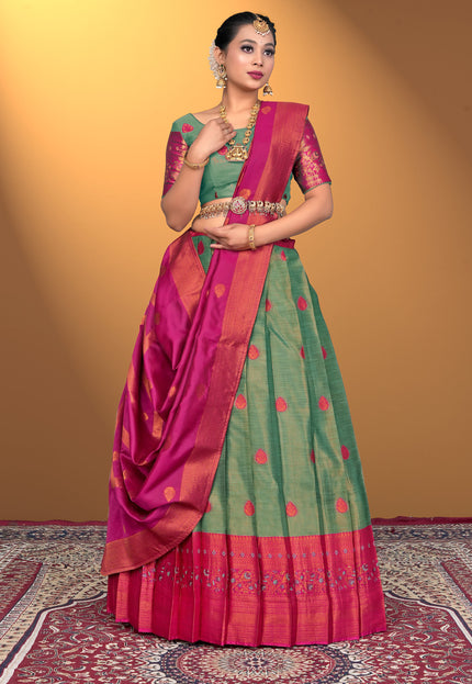Woman wearing a green and pink lehenga with a green blouse