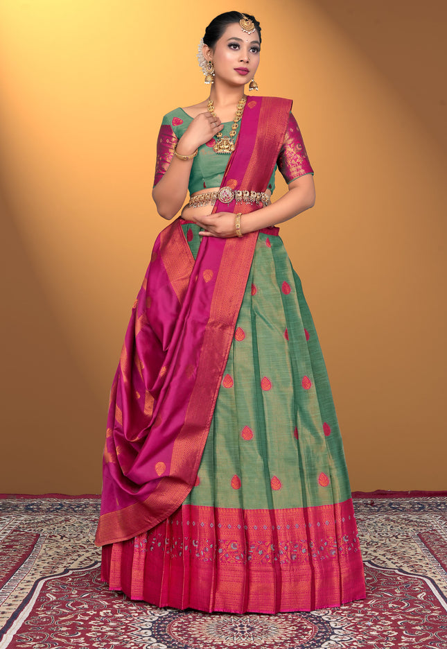 Woman wearing a green and pink lehenga with a green blouse