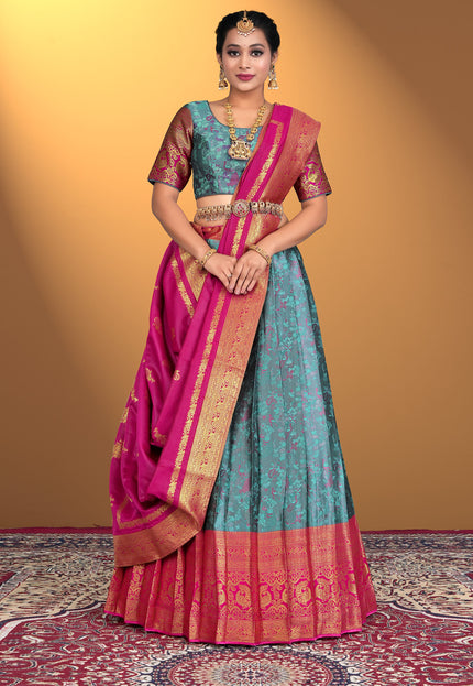 Woman wearing a traditional lehenga choli with a pink and blue color scheme