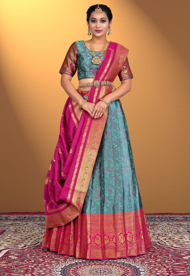 Woman wearing a traditional lehenga choli with a pink and blue color scheme