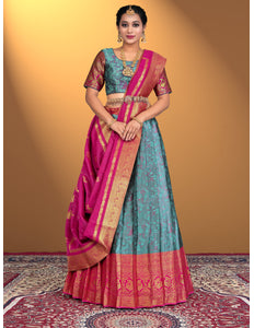 Woman wearing a traditional lehenga choli with a pink and blue color scheme
