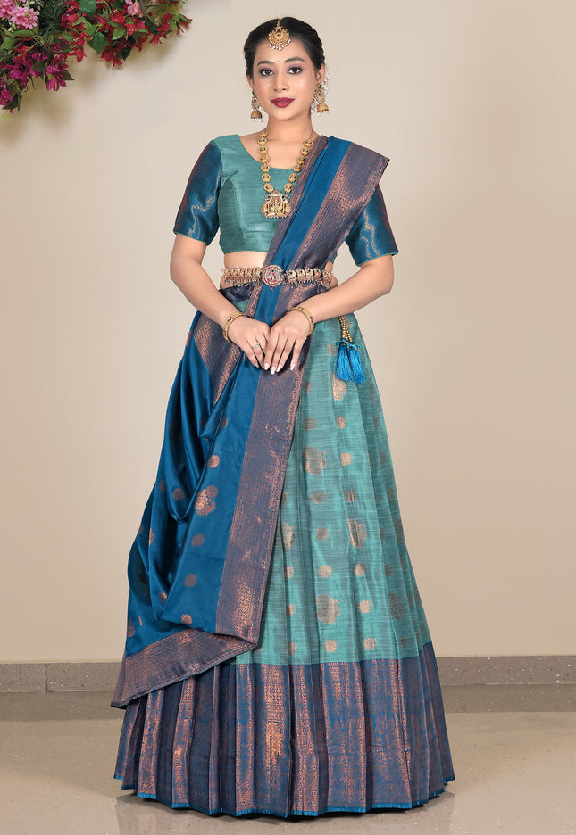 Woman wearing a traditional sea green lehenga with a matching blouse