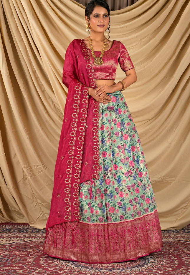 Woman wearing a traditional outfit with a pink dupatta and floral skirt