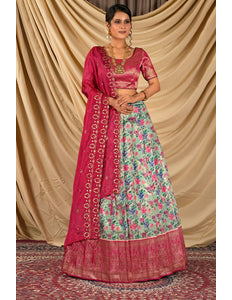 Woman wearing a traditional outfit with a pink dupatta and floral skirt