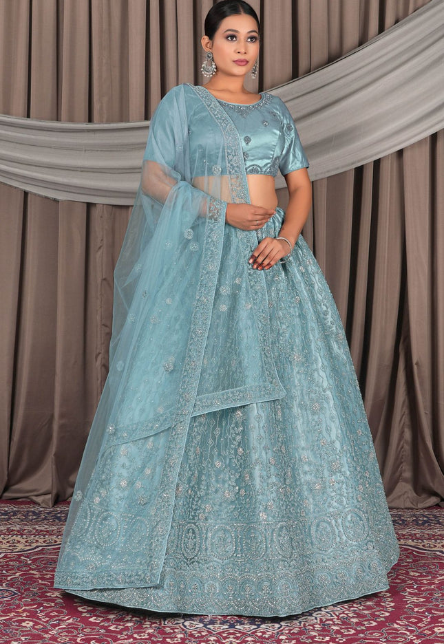 Woman wearing a light blue embroidered traditional outfit