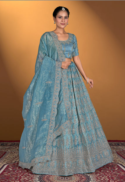 Woman wearing a blue traditional outfit with a matching dupatta