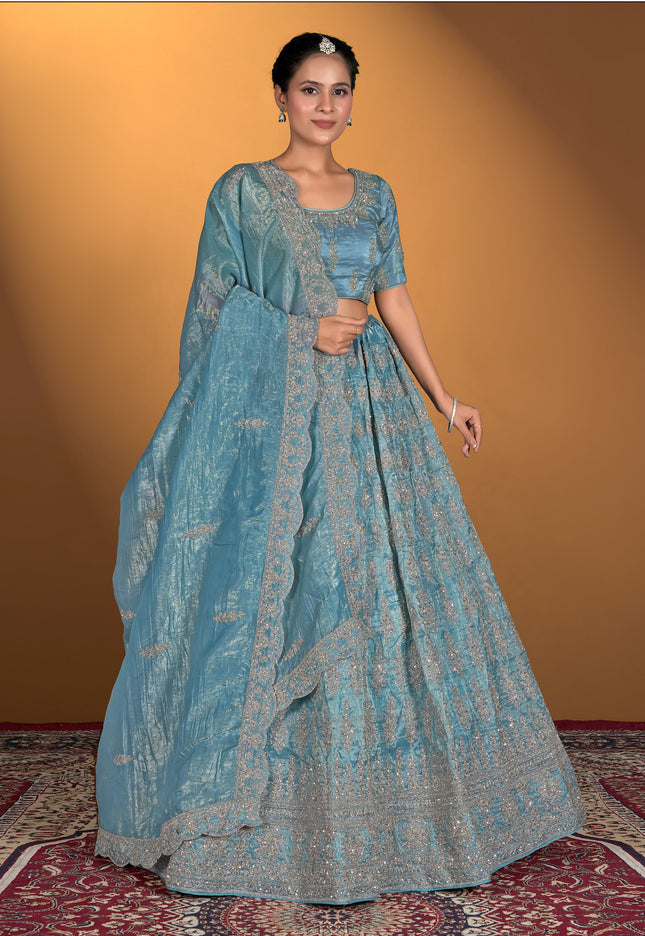 Woman wearing a blue traditional outfit with a matching dupatta