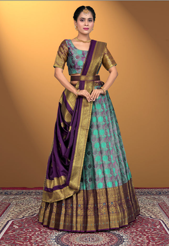Woman wearing a traditional outfit with a purple and sea green lehenga choli