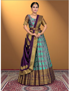 Woman wearing a traditional outfit with a purple and sea green lehenga choli