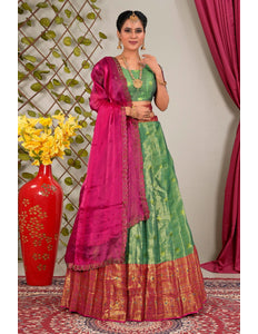 Woman wearing a green and pink traditional lehenga choli with dupatta