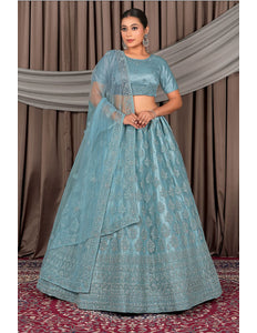 Woman wearing a traditional blue embroidered outfit