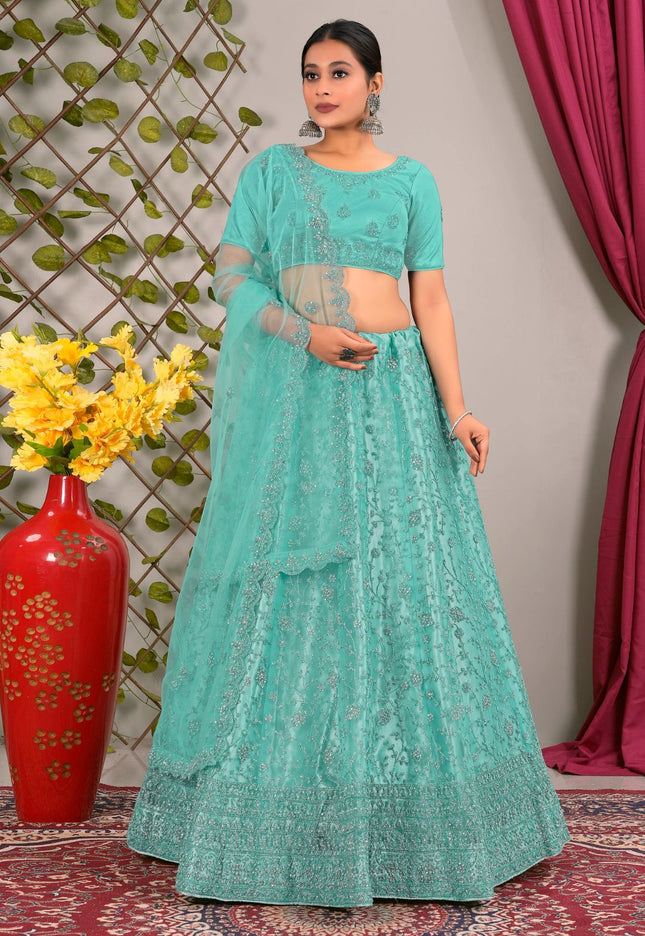 Woman in a teal traditional lehenga choli with matching dupatta
