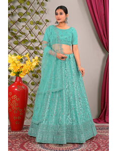 Woman in a teal traditional lehenga choli with matching dupatta