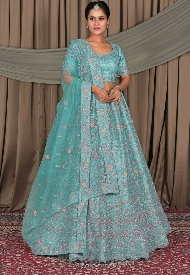 Woman in a teal floral traditional outfit