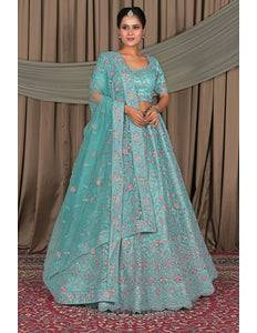 Woman in a teal floral traditional outfit