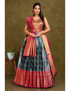 Woman wearing a traditional outfit with a green and pink patterned gown