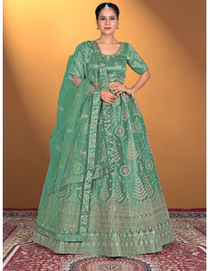 Woman wearing a green embroidered traditional outfit