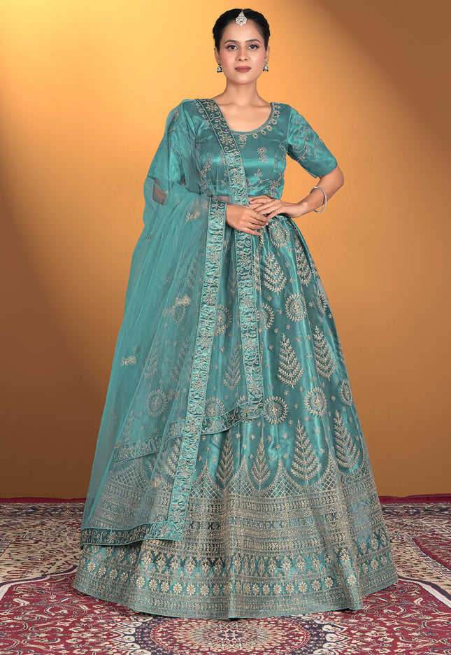 Woman wearing a teal embroidered traditional outfit