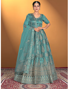 Woman wearing a teal embroidered traditional outfit
